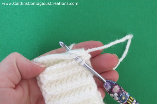 Cascading Icicles Beanie Crochet Pattern a free design from Caitlin's Contagious Creations. This fun and easy winter hat crochet pattern has an option for a messy bun ponytail hat too!! The pattern features written directions and step by step photo instructions. Get started on yours now!