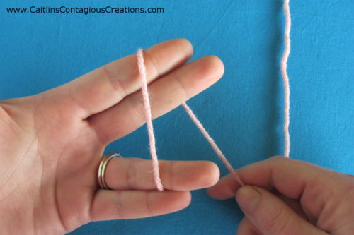 wrap yarn around forefinger and middle finger