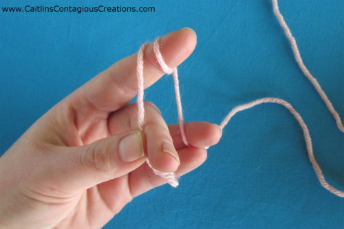 hold yarn between pinky and ring finger to stabilize