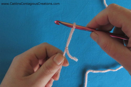 pull on working end of yarn to tighten loop around throat of hook