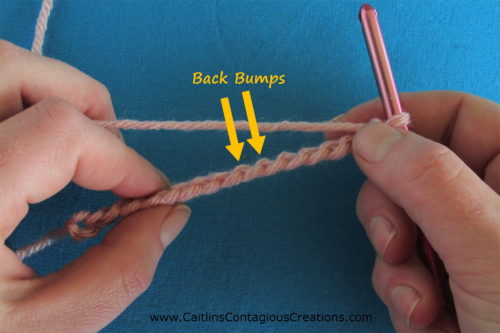 crochet chain backside with yellow arrows pointing to back bumps