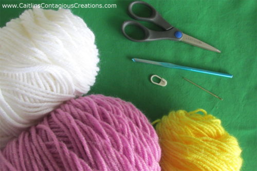 Yarn hook scissors and stitch markers needed to complete daisy square