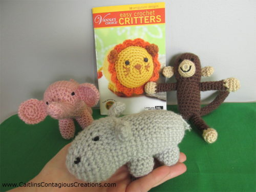 Easy crochet critters book with amigurumi elephant, monkey, and hippo in the foreground