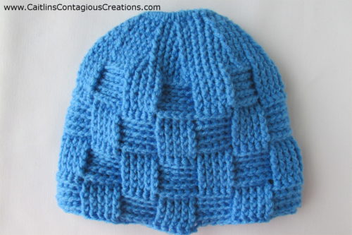 finished long version of basket weave ponytail hat in light blue.