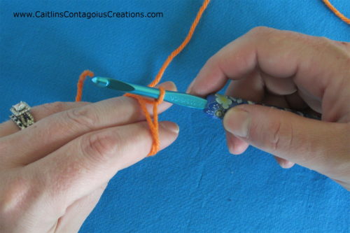 rotate hook to grab yarn loop around throat of hook
