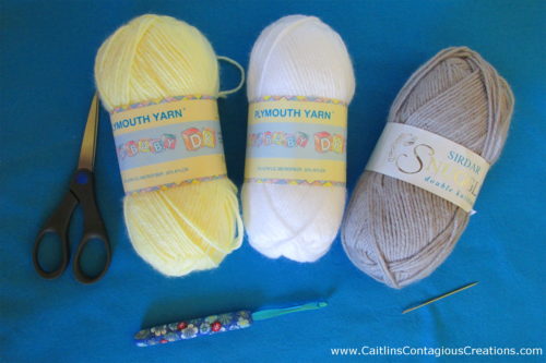supplies needed for this free crochet pattern, 3 colors of dk yarn, h8 crochet hook, scissors, and yarn needle