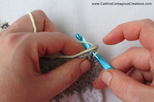 step 2 of stnading single crochet: insert hook into stitch.