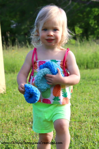 little girl carrying reusable water balloons